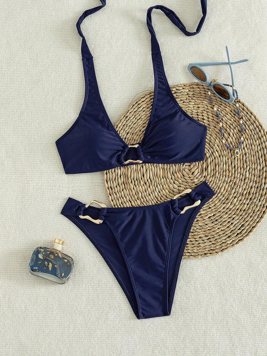 Women's 2-piece solid color halter bikini set featuring a backless tie-back wireless top and mid-waist swimsuit bottoms.