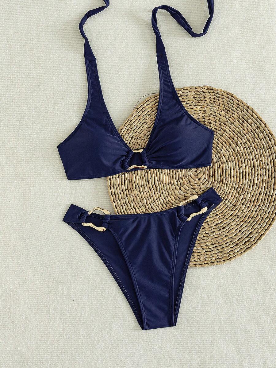Women's 2-piece solid color halter bikini set featuring a backless tie-back wireless top and mid-waist swimsuit bottoms.