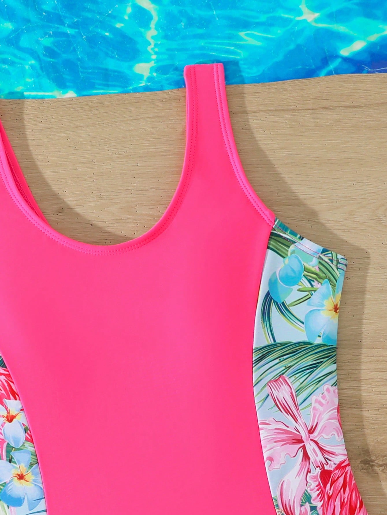 Tween girls 2-piece swimsuit set in black with full floral and plant print, featuring a sleeveless scoop-neck swim top and matching shorts-style bottoms.
