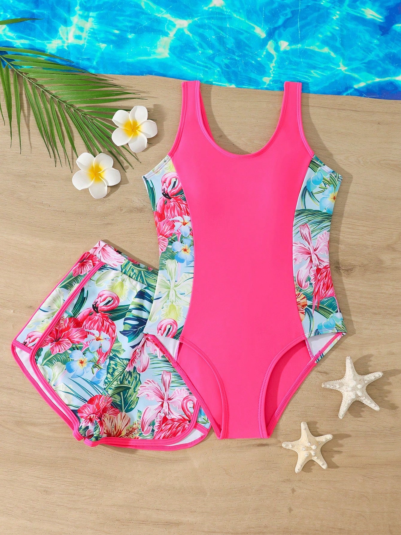 Tween girls 2-piece swimsuit set in black with full floral and plant print, featuring a sleeveless scoop-neck swim top and matching shorts-style bottoms.