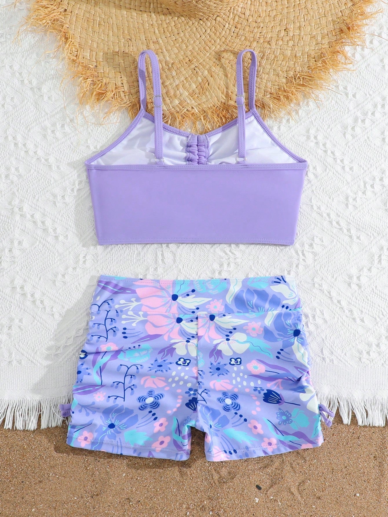Tween girl tropical print ruched bikini set with spaghetti strap top and shorts-style bottoms, wireless design, high-stretch fabric, shown in hot pink.