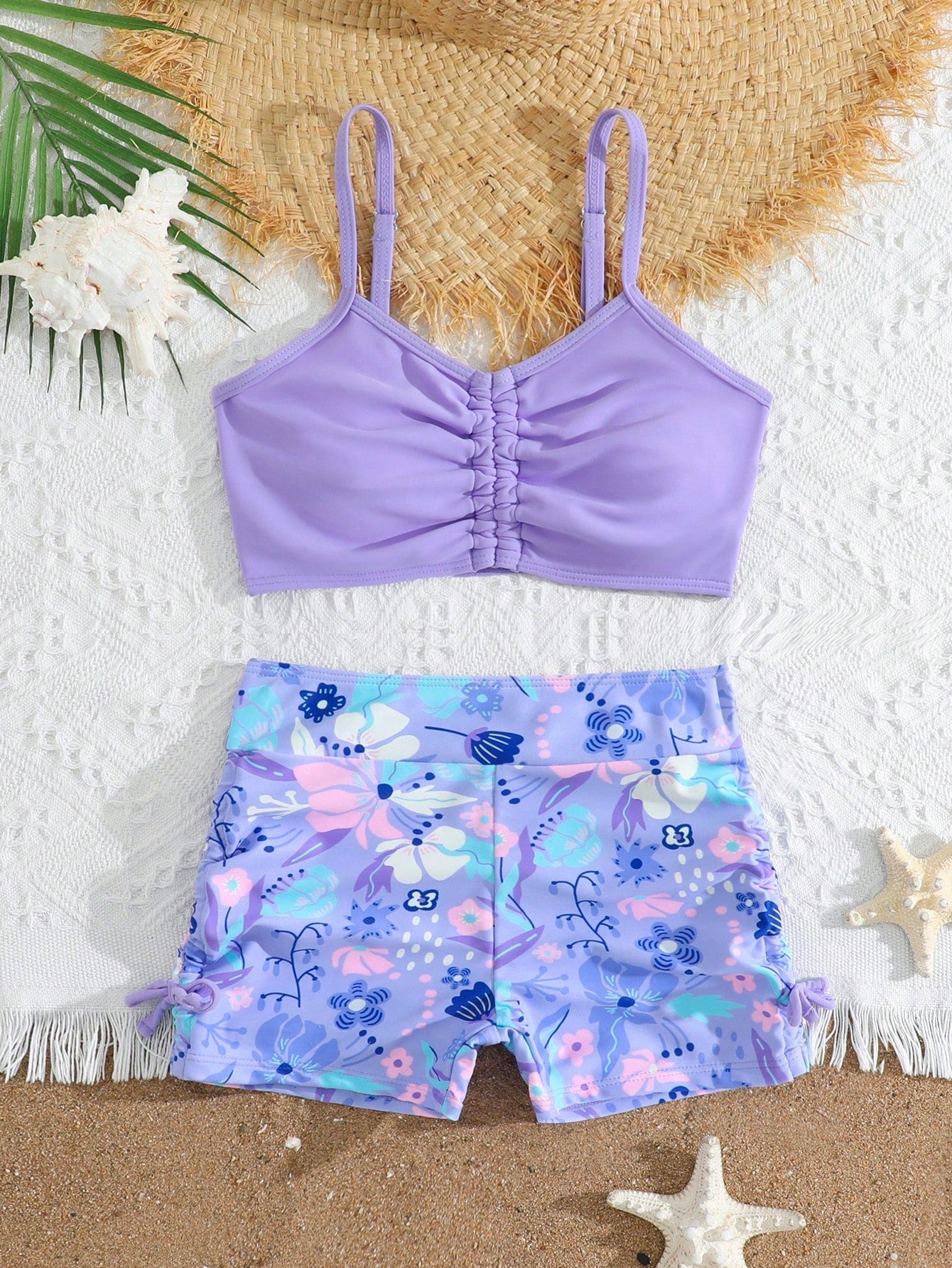 Tween girl tropical print ruched bikini set with spaghetti strap top and shorts-style bottoms, wireless design, high-stretch fabric, shown in hot pink.