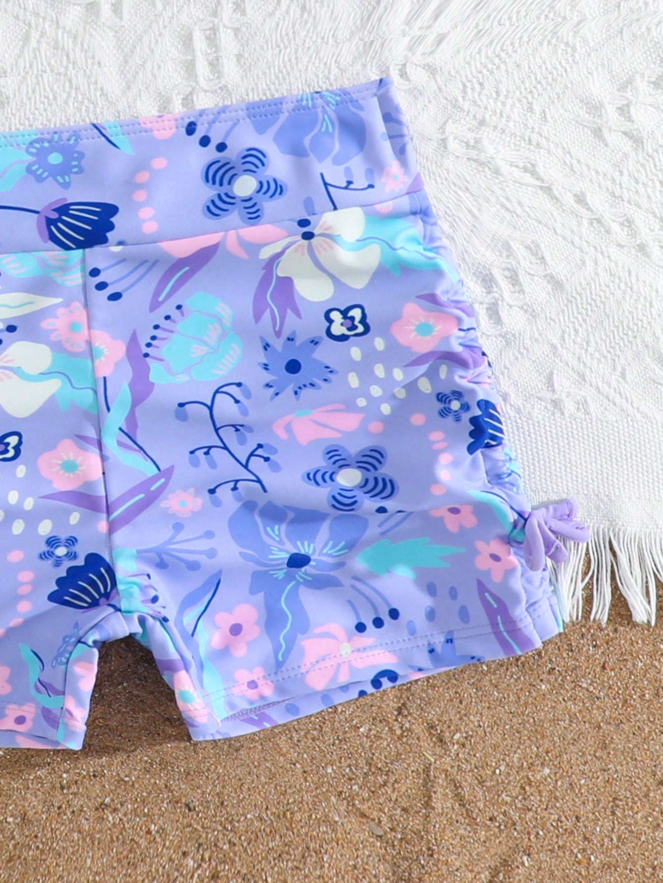 Tween girl tropical print ruched bikini set with spaghetti strap top and shorts-style bottoms, wireless design, high-stretch fabric, shown in hot pink.