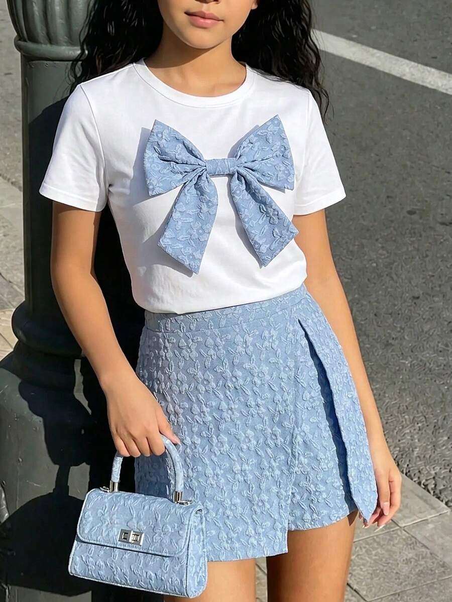Tween girls 2-piece blue outfit featuring a short sleeve round neck t-shirt with a bow front detail and an asymmetric wrap skort.