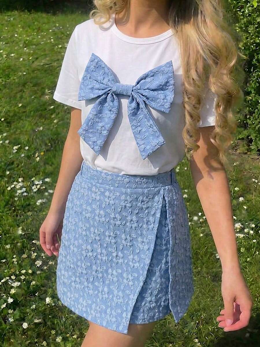 Tween girls 2-piece blue outfit featuring a short sleeve round neck t-shirt with a bow front detail and an asymmetric wrap skort.