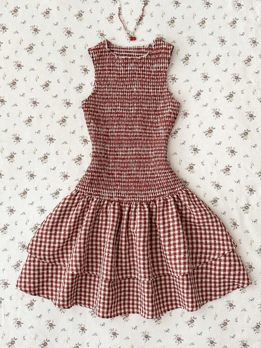 Tween girls sleeveless A-line mini dress in red and white plant pattern featuring round neck, high waist with ruffle and button details, and flounce hem.
