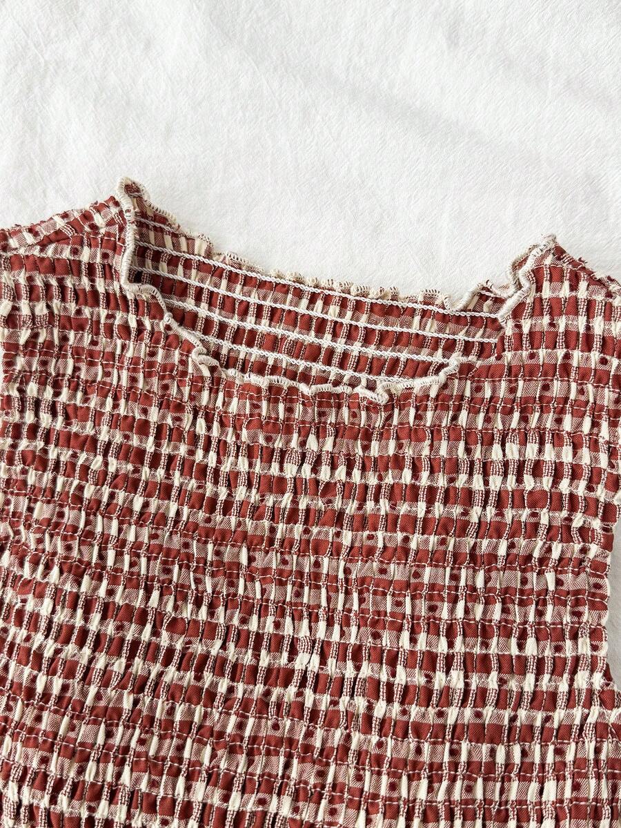 Tween girls sleeveless A-line mini dress in red and white plant pattern featuring round neck, high waist with ruffle and button details, and flounce hem.