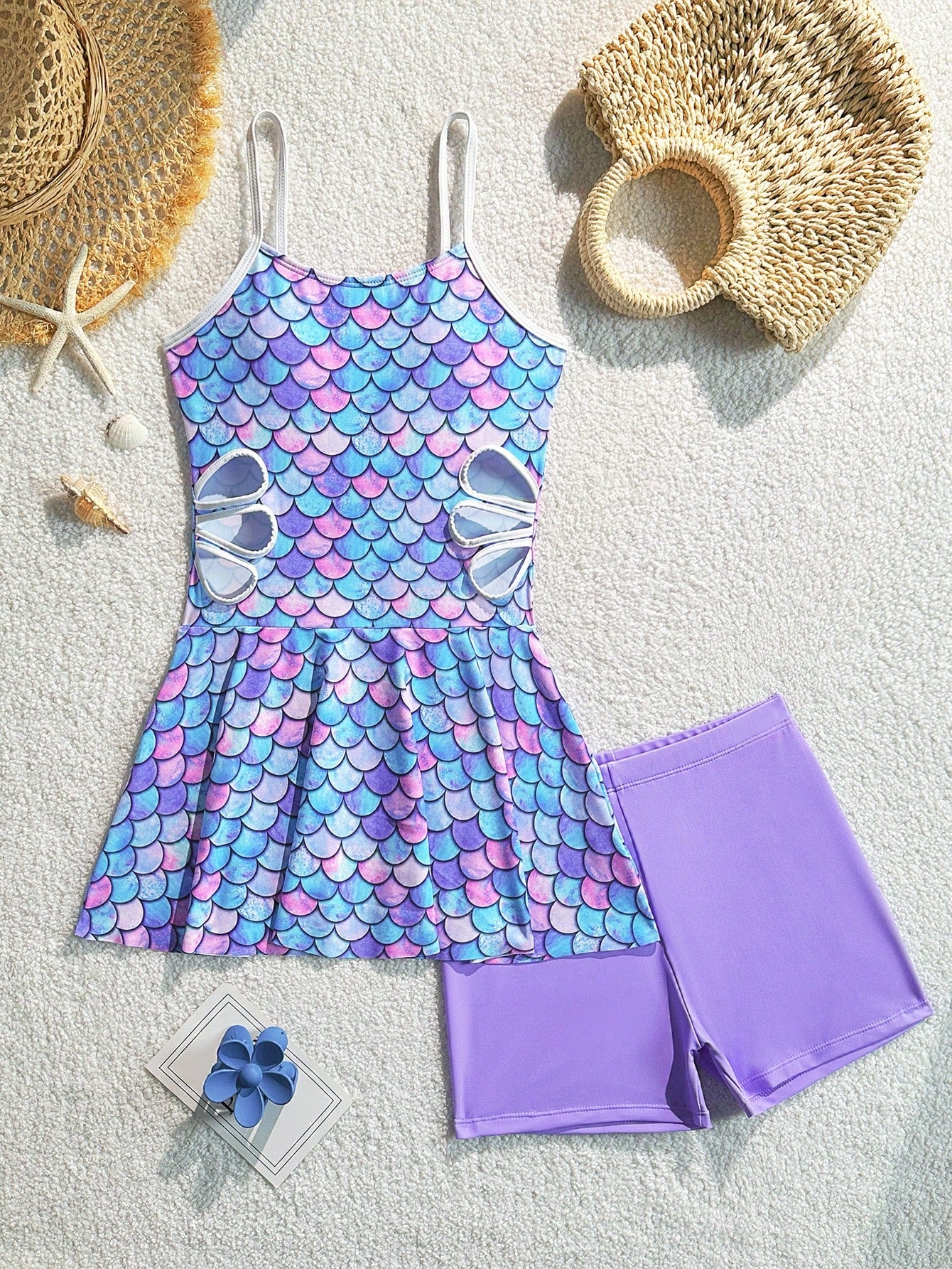 Tween girls black two-piece tankini swimwear set featuring a spaghetti strap sleeveless top with cutout detail and contrast piping, paired with short swim shorts.