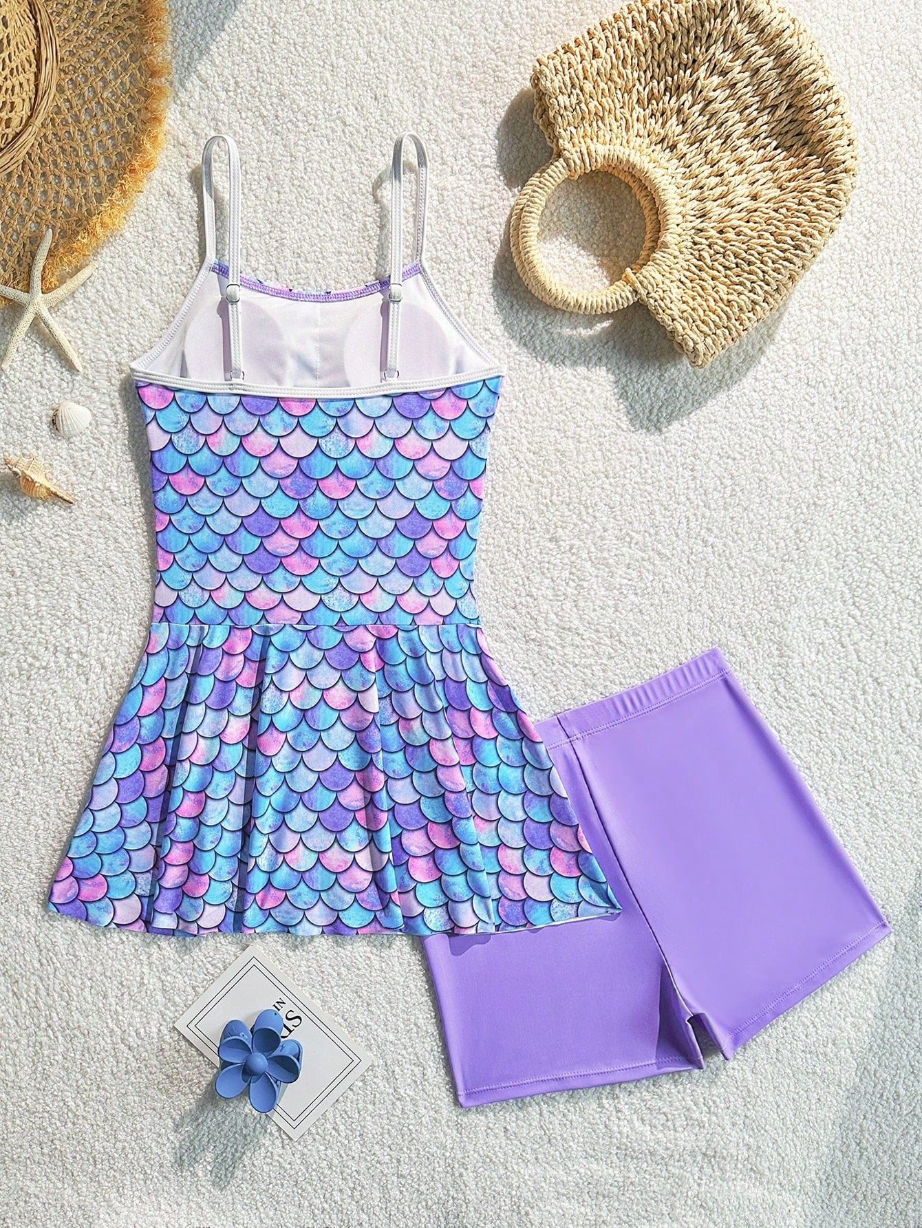 Tween girls black two-piece tankini swimwear set featuring a spaghetti strap sleeveless top with cutout detail and contrast piping, paired with short swim shorts.