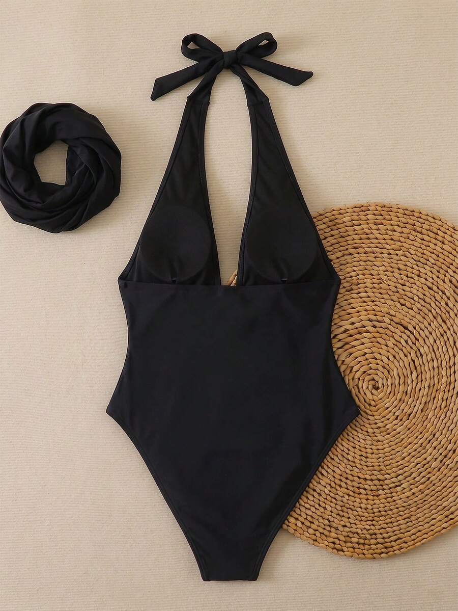 Women's apricot polka dot two-piece swimsuit featuring an asymmetrical halter backless top with knot tie detail and high-waisted bottoms.