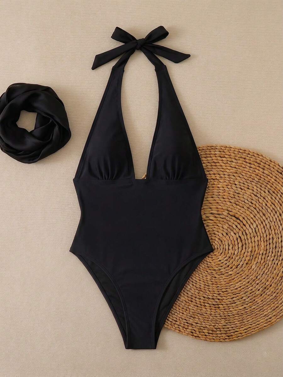Women's apricot polka dot two-piece swimsuit featuring an asymmetrical halter backless top with knot tie detail and high-waisted bottoms.