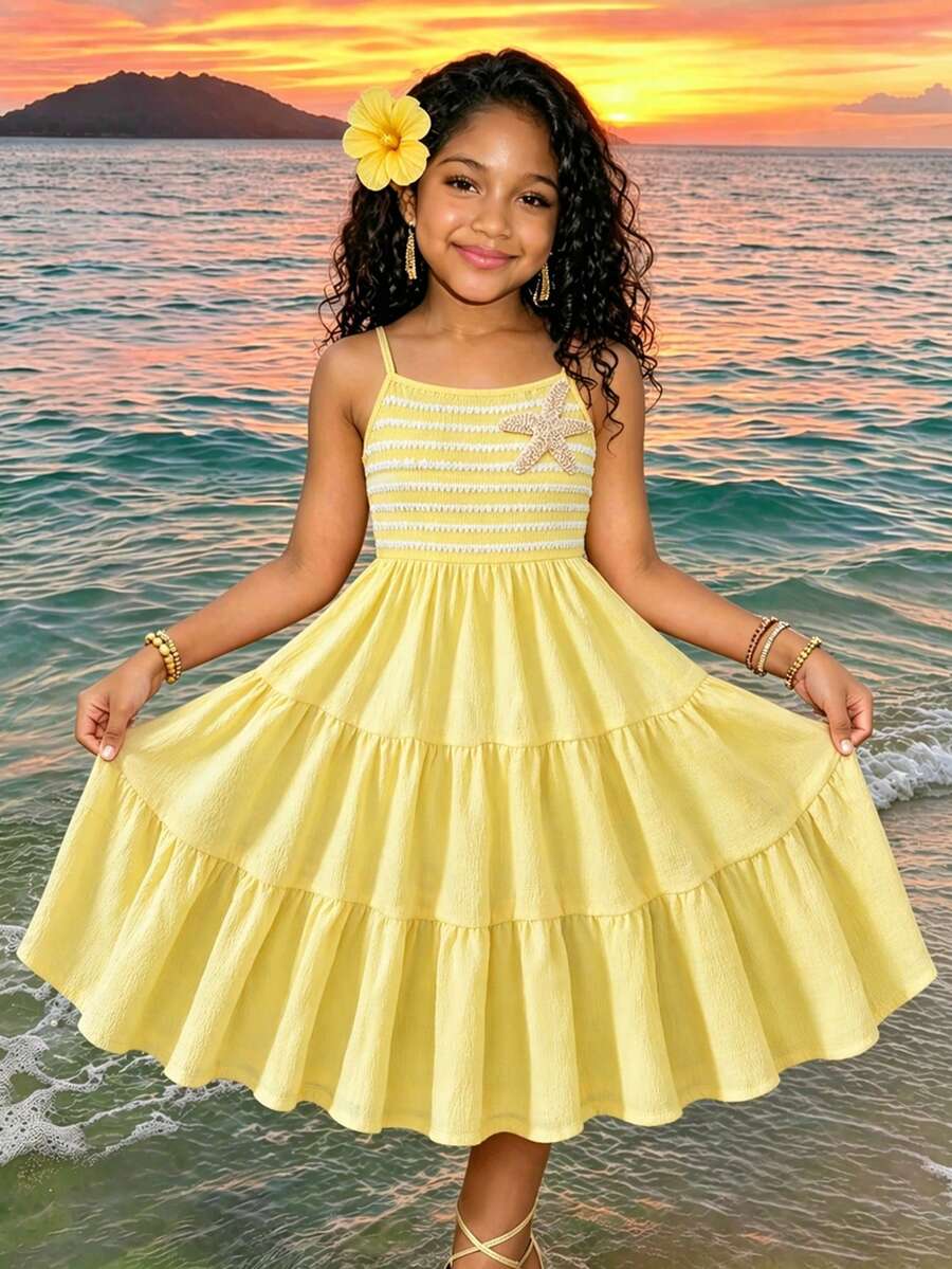 Tween girls yellow sleeveless cami dress with spaghetti straps, high waist, tiered layered skirt, shirred detail, zipper closure, and casual vacation style.
