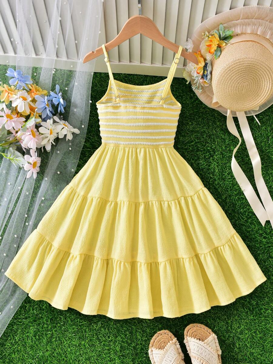 Tween girls yellow sleeveless cami dress with spaghetti straps, high waist, tiered layered skirt, shirred detail, zipper closure, and casual vacation style.