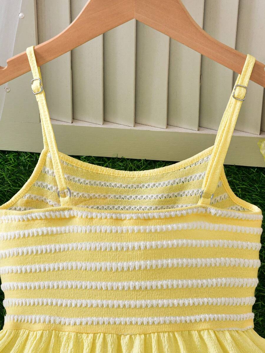 Tween girls yellow sleeveless cami dress with spaghetti straps, high waist, tiered layered skirt, shirred detail, zipper closure, and casual vacation style.