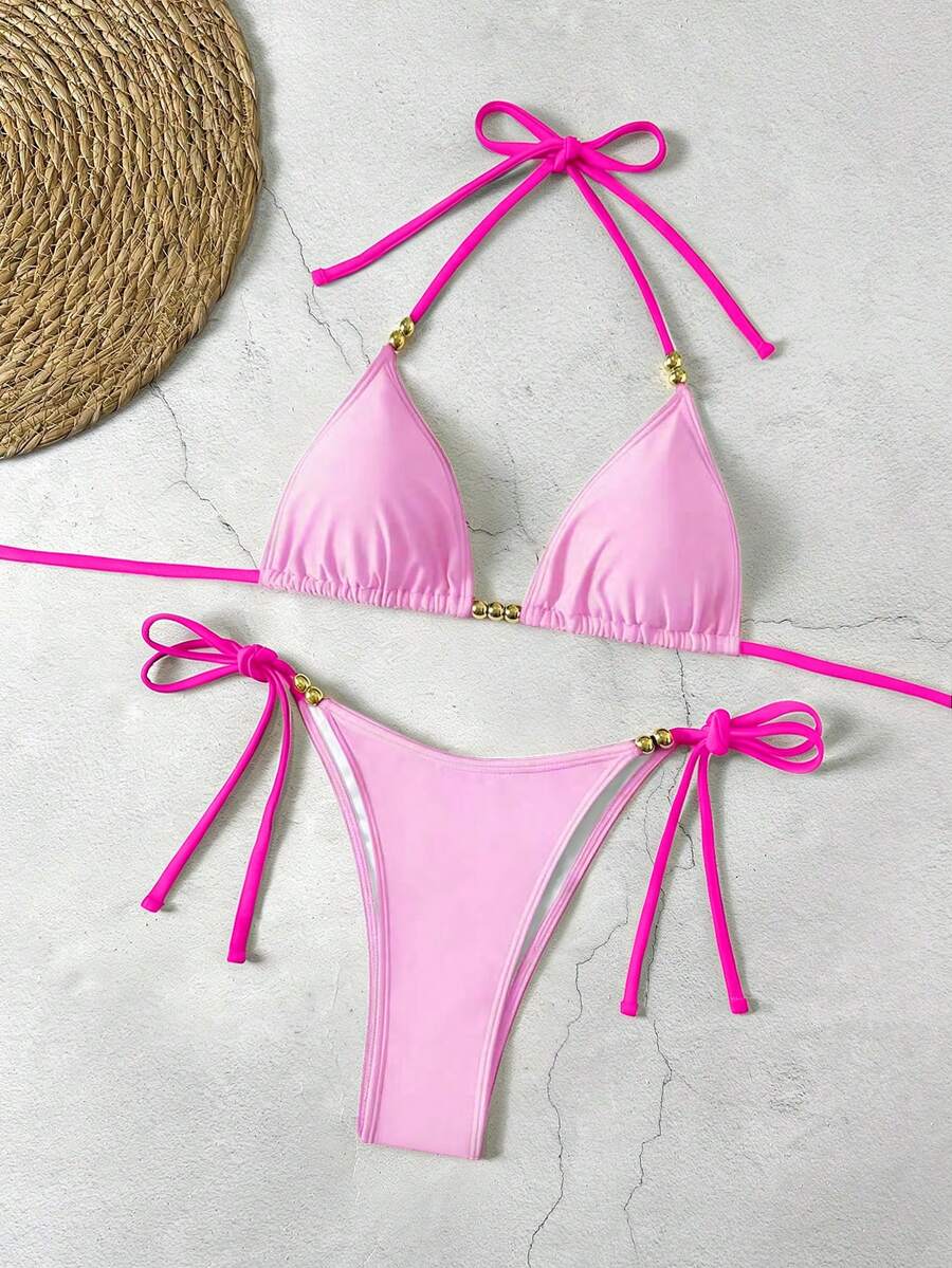 Women's black halter bikini set featuring triangle cups with gold bead decor and tie-back closure