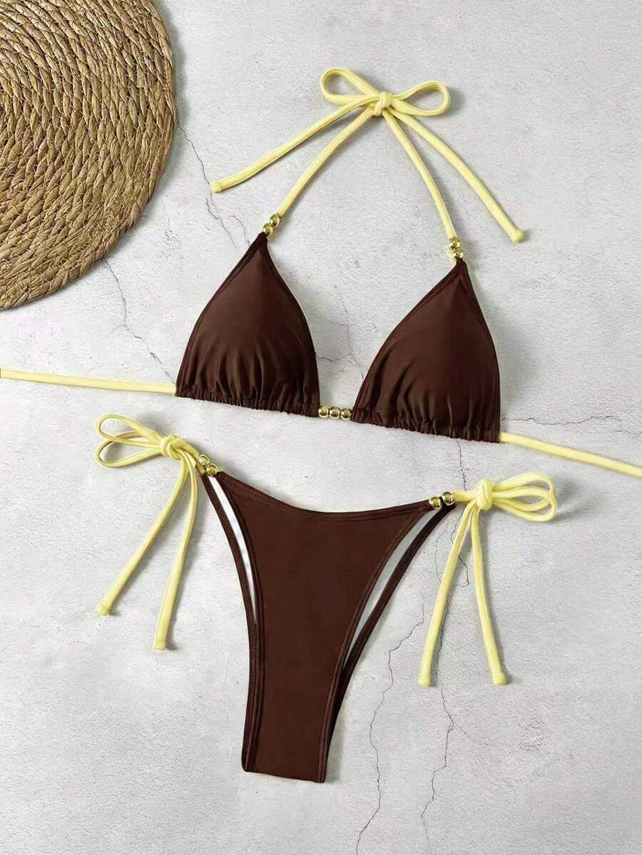 Women's black halter bikini set featuring triangle cups with gold bead decor and tie-back closure