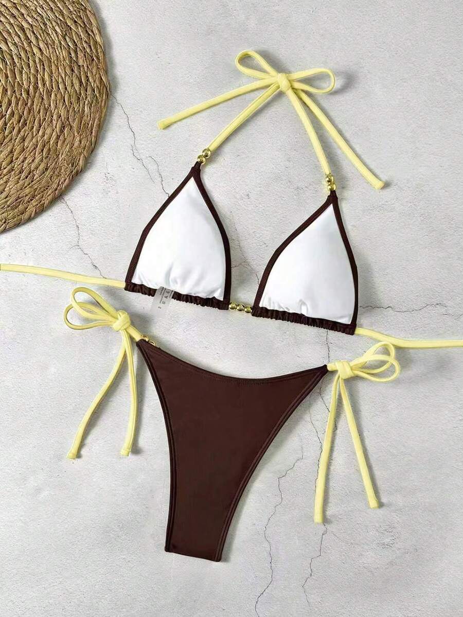 Women's black halter bikini set featuring triangle cups with gold bead decor and tie-back closure