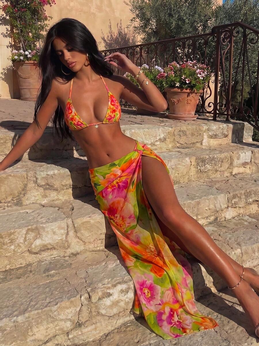 Women's 3-piece floral swimsuit set featuring a multicolor tie-back halter bikini top, low-waist bottoms, and a matching sheer mesh maxi skirt.