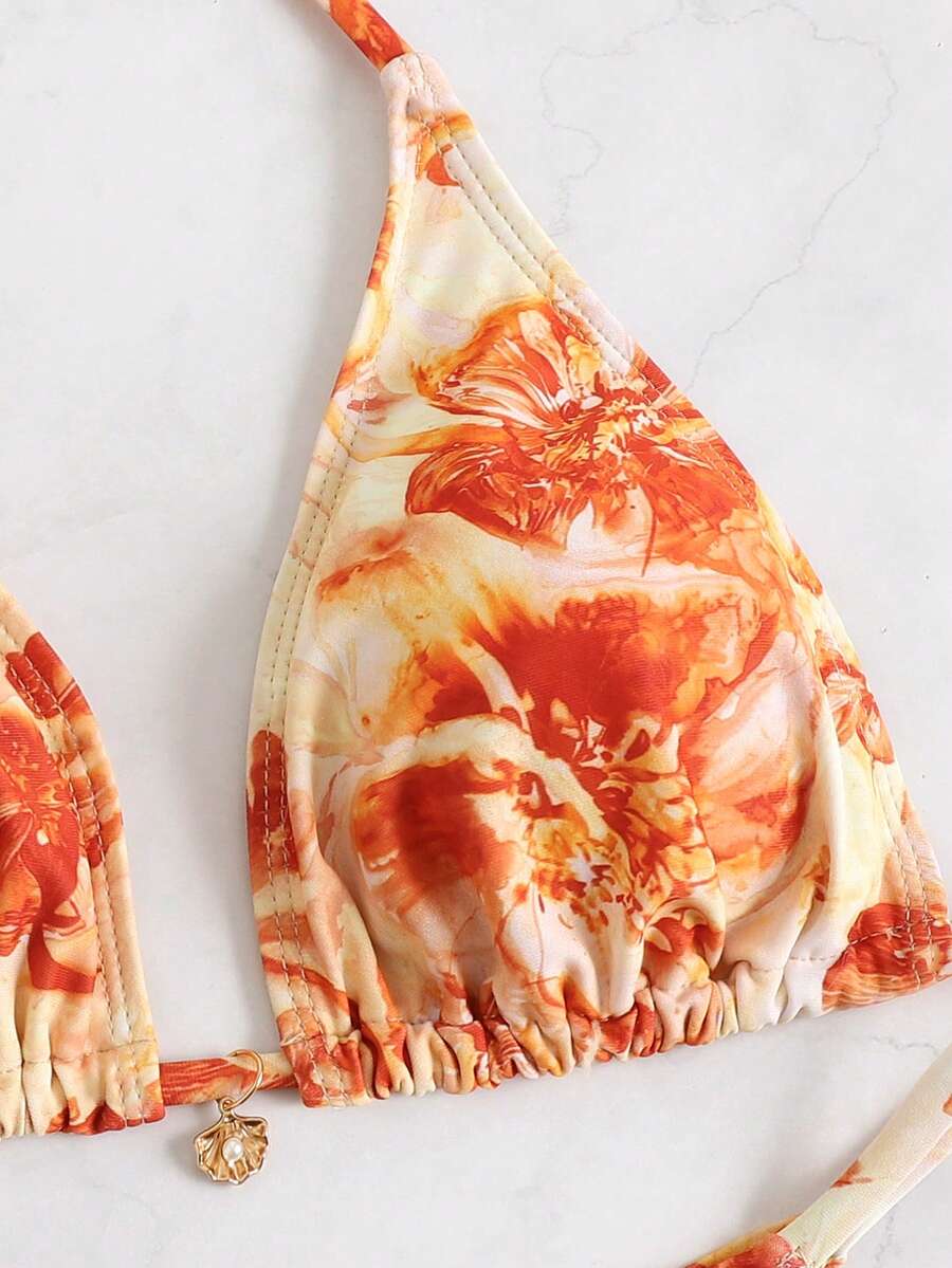 Women's 3-piece floral swimsuit set featuring a multicolor tie-back halter bikini top, low-waist bottoms, and a matching sheer mesh maxi skirt.
