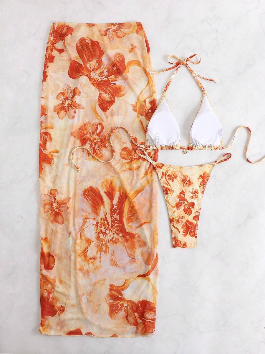 Women's 3-piece floral swimsuit set featuring a multicolor tie-back halter bikini top, low-waist bottoms, and a matching sheer mesh maxi skirt.