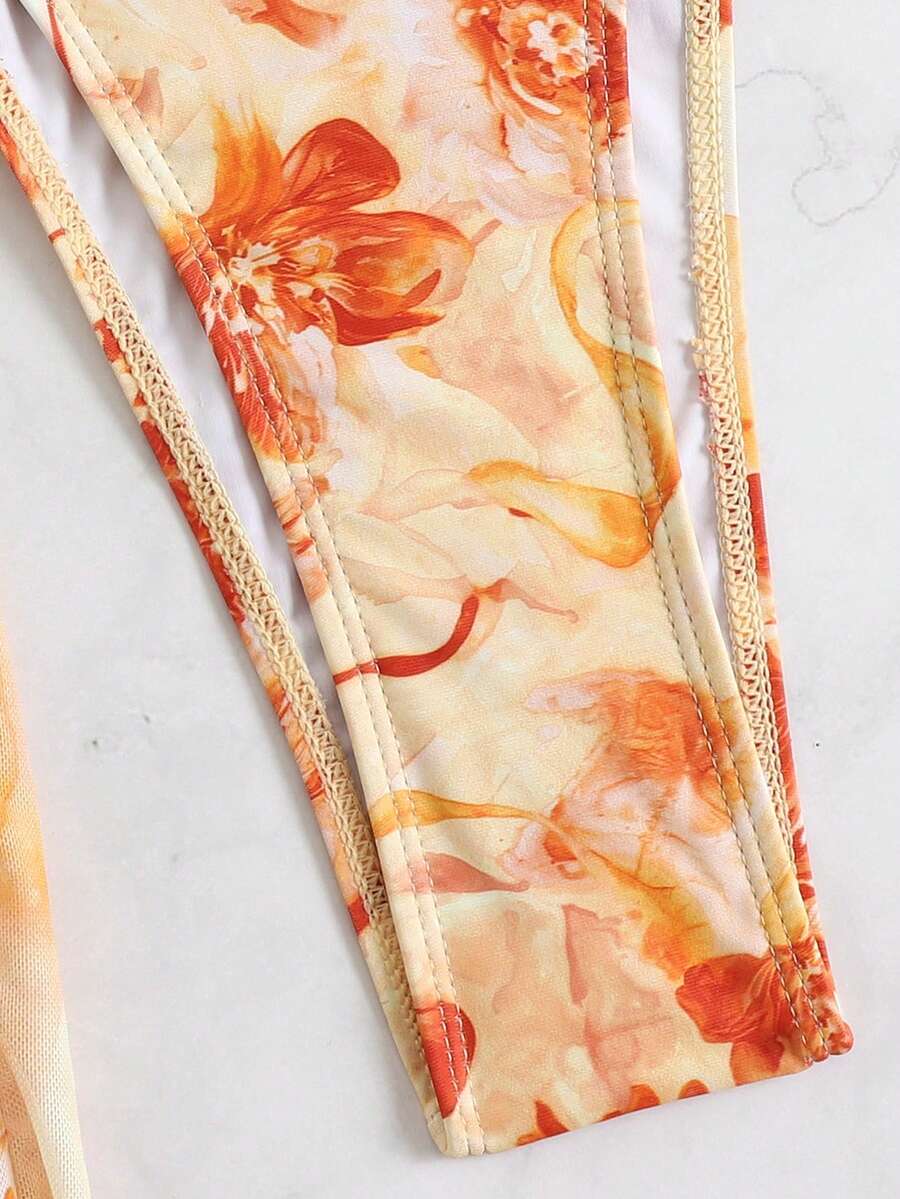 Women's 3-piece floral swimsuit set featuring a multicolor tie-back halter bikini top, low-waist bottoms, and a matching sheer mesh maxi skirt.