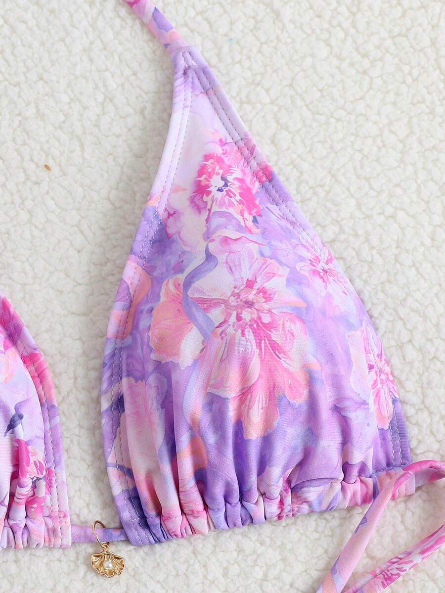 Women's 3-piece floral swimsuit set featuring a multicolor tie-back halter bikini top, low-waist bottoms, and a matching sheer mesh maxi skirt.