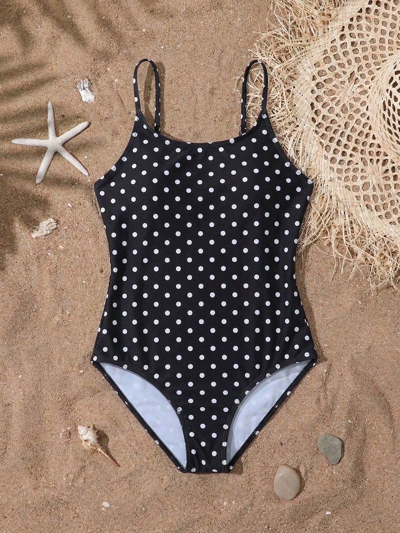 Tween girls one-piece swimsuit with multicolor ocean shell and seahorse all-over print, spaghetti straps, cut-out detail, and lined body for beach or swimming.