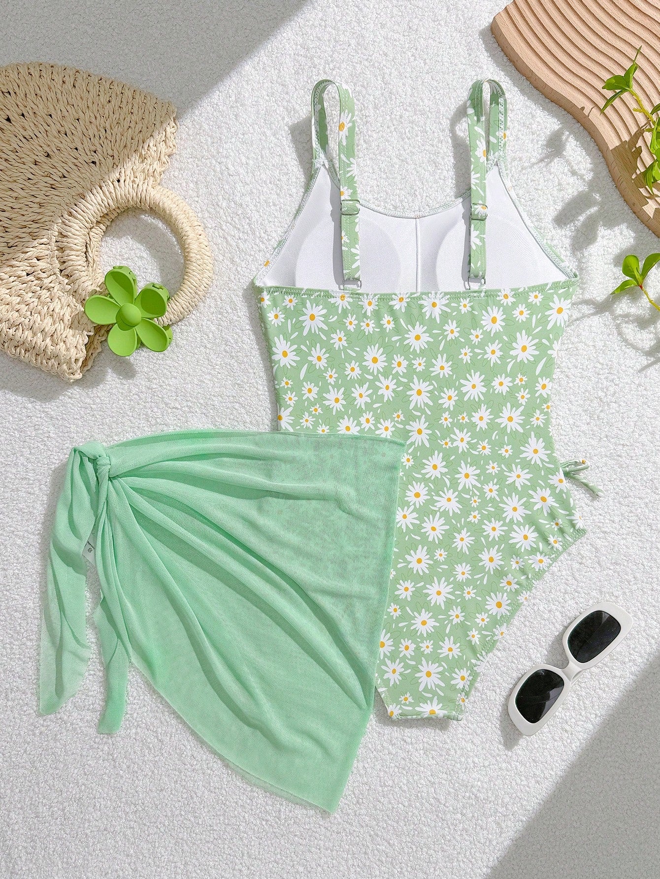 Tween girls 2-piece swimsuit in black with pink floral print, featuring spaghetti straps, bow decor, mesh detail, and a skirted mid-waist bottom. Sleeveless vacation-style swim set with medium-stretch fabric.