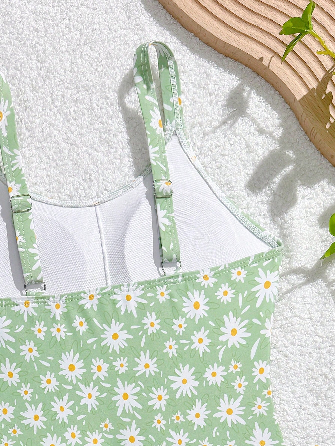 Tween girls 2-piece swimsuit in black with pink floral print, featuring spaghetti straps, bow decor, mesh detail, and a skirted mid-waist bottom. Sleeveless vacation-style swim set with medium-stretch fabric.