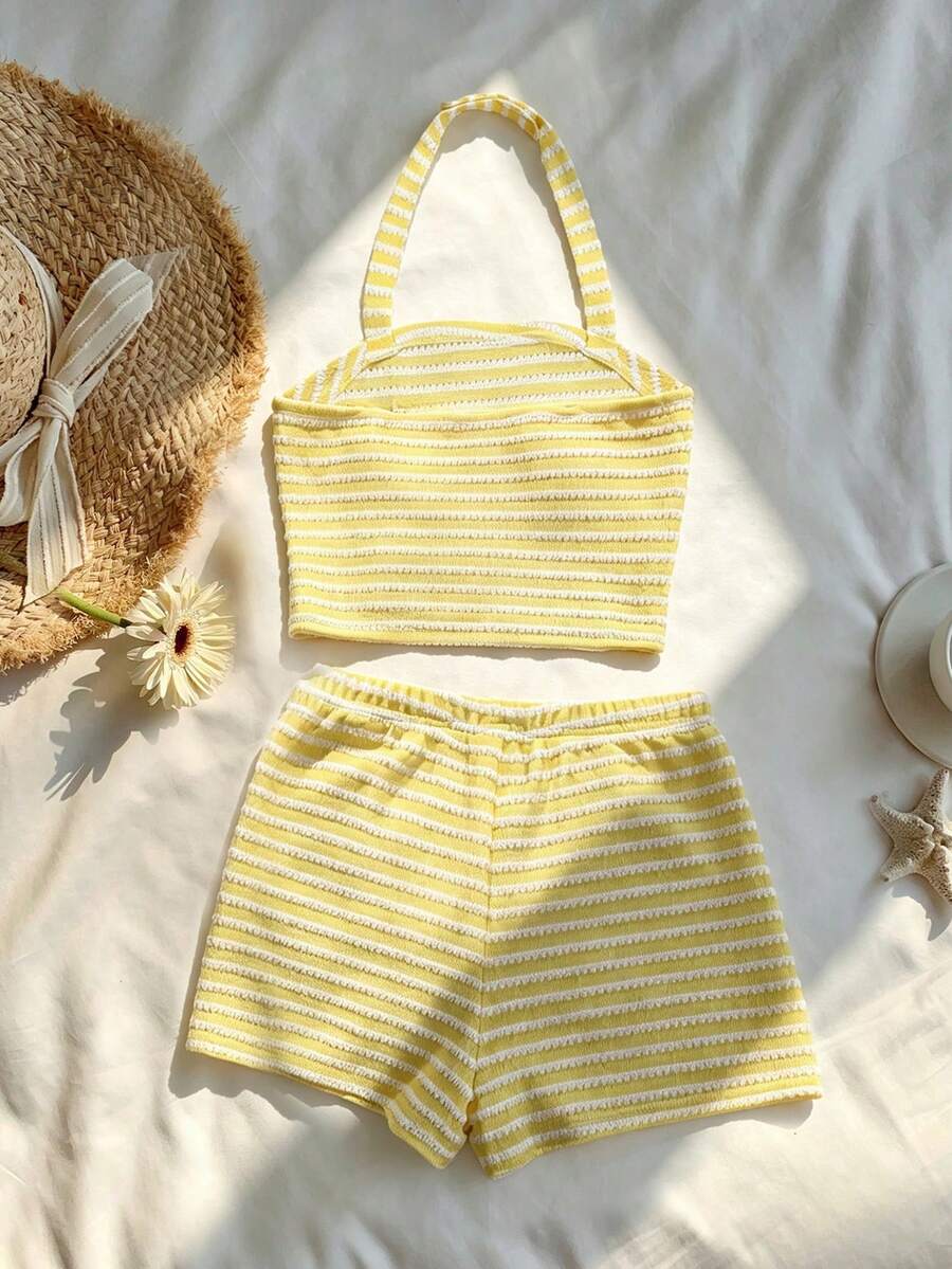 Tween girls black and white striped two-piece set featuring a spaghetti strap micro crop tank top with lettuce trim and ruffle hem paired with matching slim fit shorts.