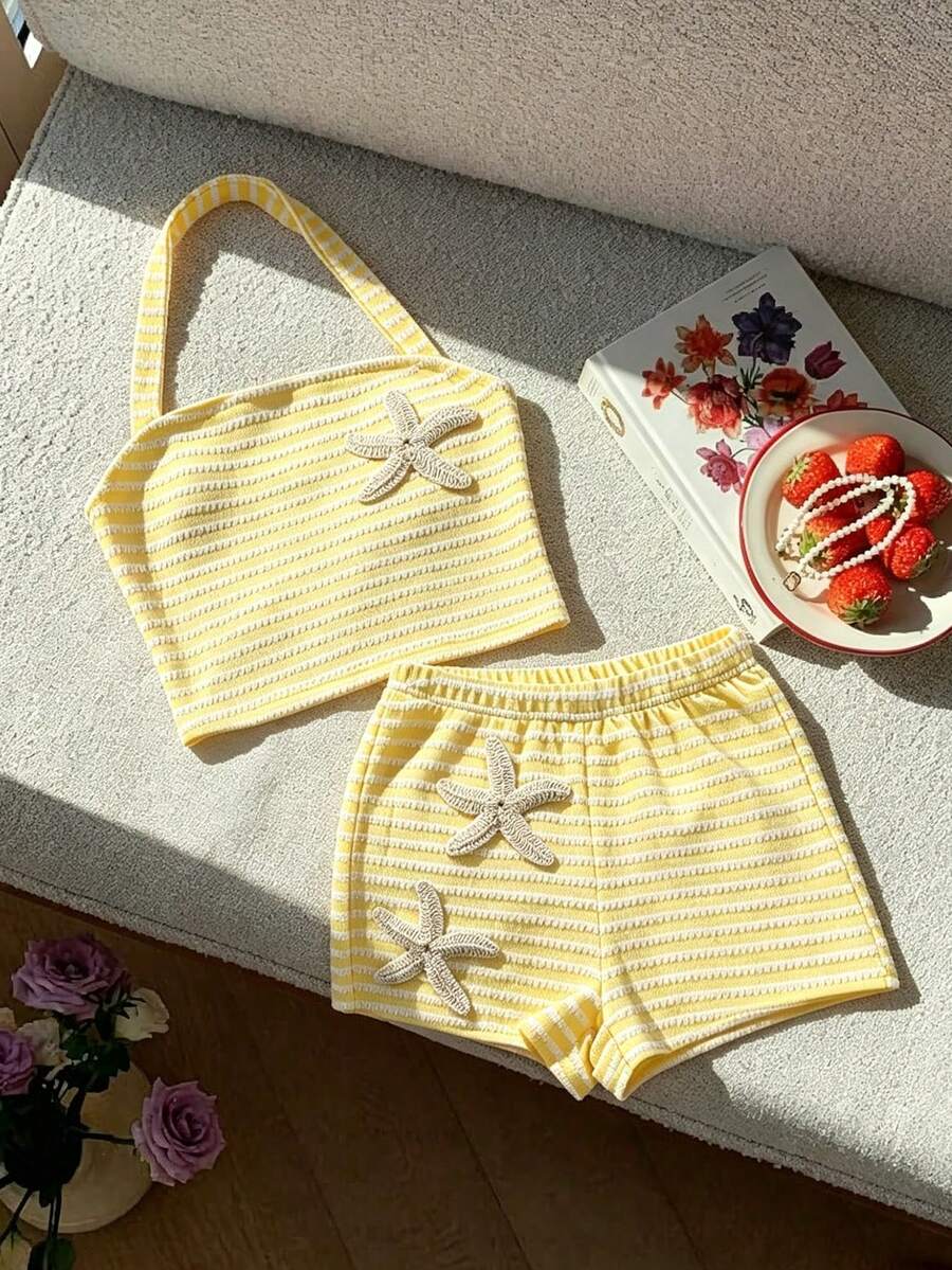 Tween girls black and white striped two-piece set featuring a spaghetti strap micro crop tank top with lettuce trim and ruffle hem paired with matching slim fit shorts.