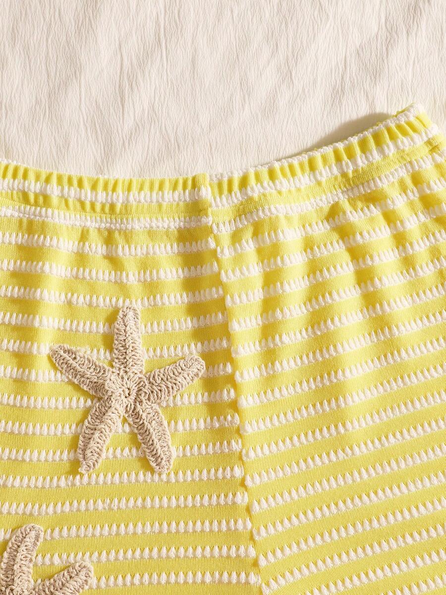 Tween girls black and white striped two-piece set featuring a spaghetti strap micro crop tank top with lettuce trim and ruffle hem paired with matching slim fit shorts.