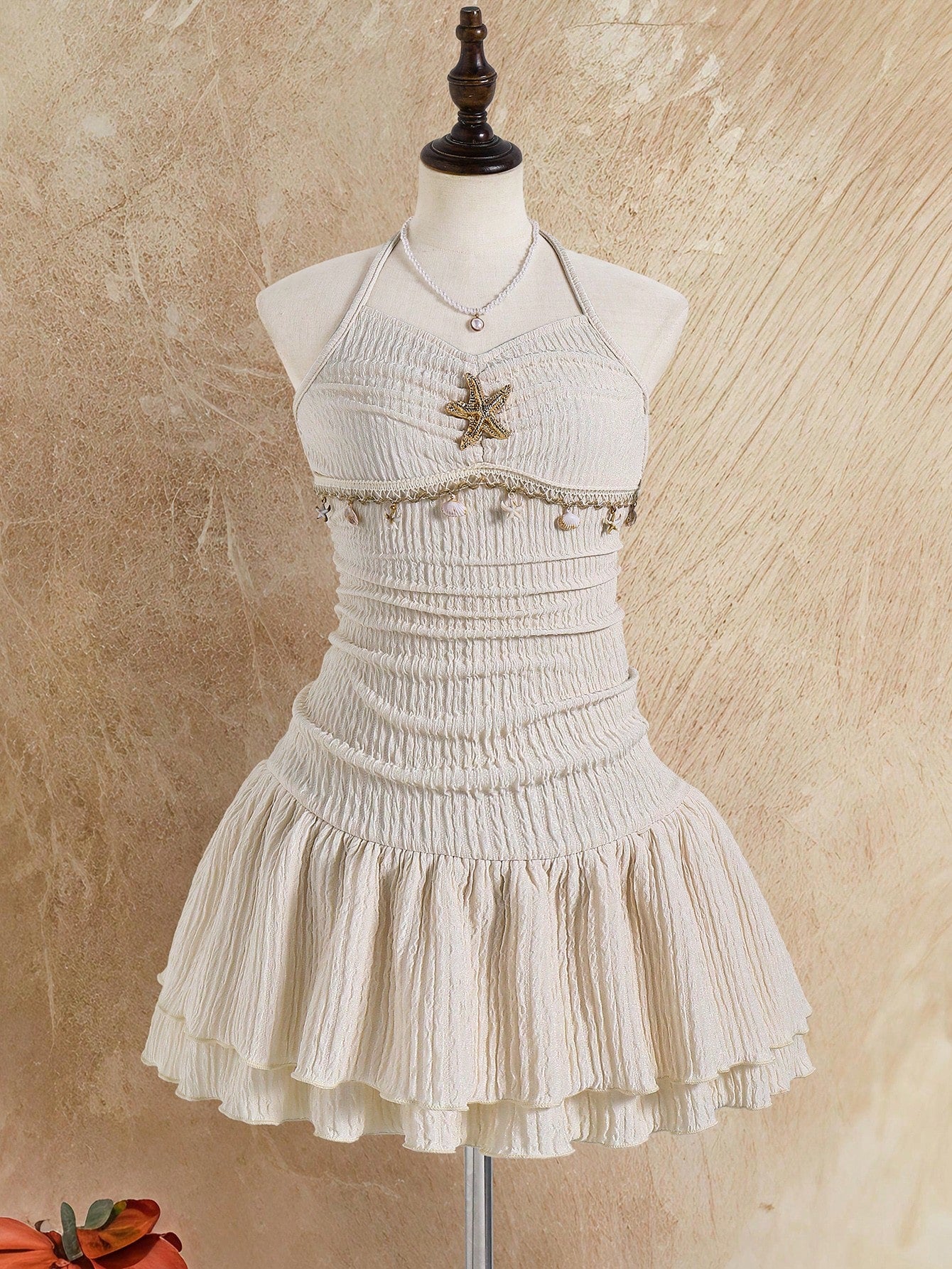Tween girls apricot sleeveless halter mini dress with textured starfish and shell decor, shirred tiered layer, high waist, and flounce hem.