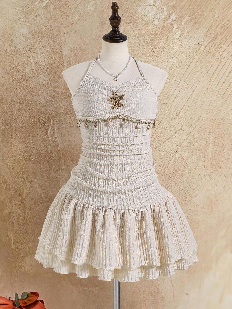 Tween girls apricot sleeveless halter mini dress with textured starfish and shell decor, shirred tiered layer, high waist, and flounce hem.