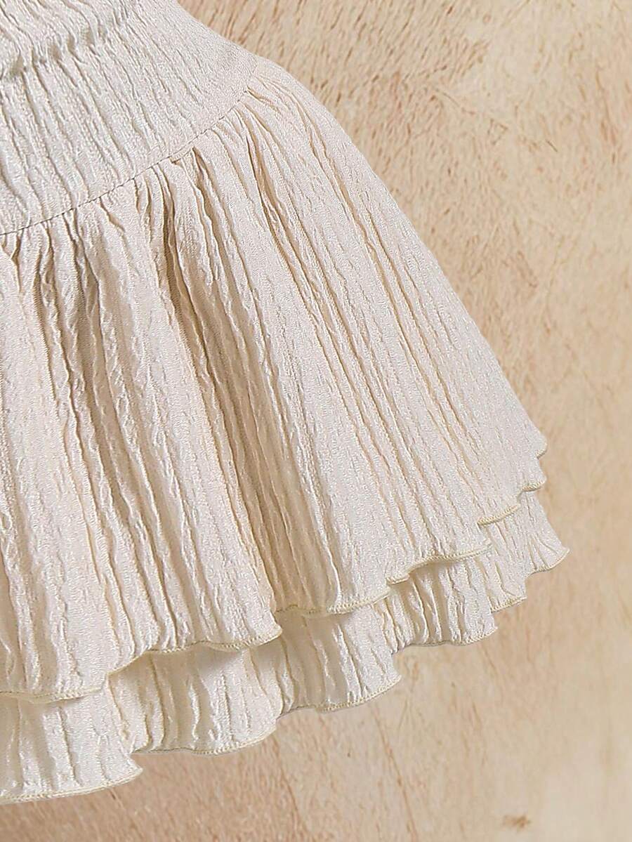Tween girls apricot sleeveless halter mini dress with textured starfish and shell decor, shirred tiered layer, high waist, and flounce hem.