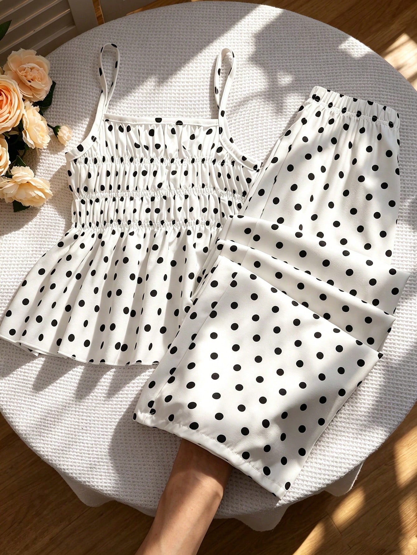 Girls 2-piece summer outfit set featuring a blue bow print camisole top with spaghetti straps and matching high-waisted straight leg pants.