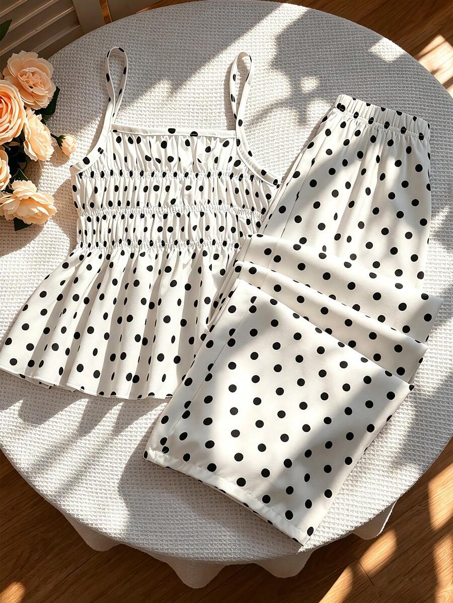 Girls 2-piece summer outfit set featuring a blue bow print camisole top with spaghetti straps and matching high-waisted straight leg pants.