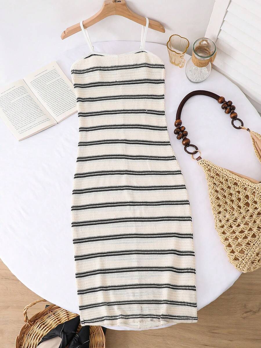 Tween girls black cami midi dress featuring plant print, spaghetti straps, slim fit, and a flared hem.