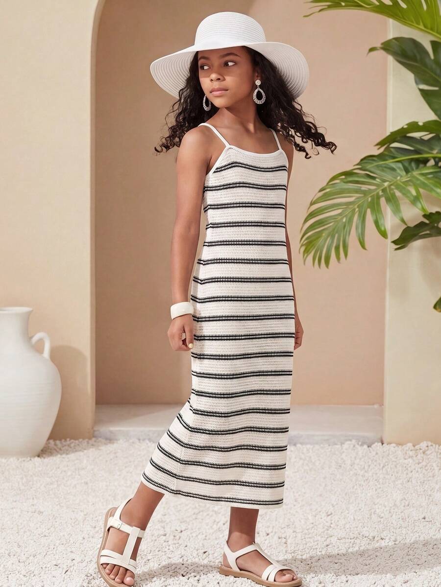 Tween girls black cami midi dress featuring plant print, spaghetti straps, slim fit, and a flared hem.