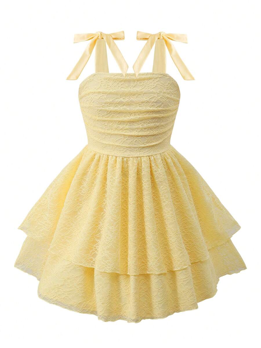 Tween girl wearing a pink tiered off-the-shoulder midi dress with shirred high waist and layered hem