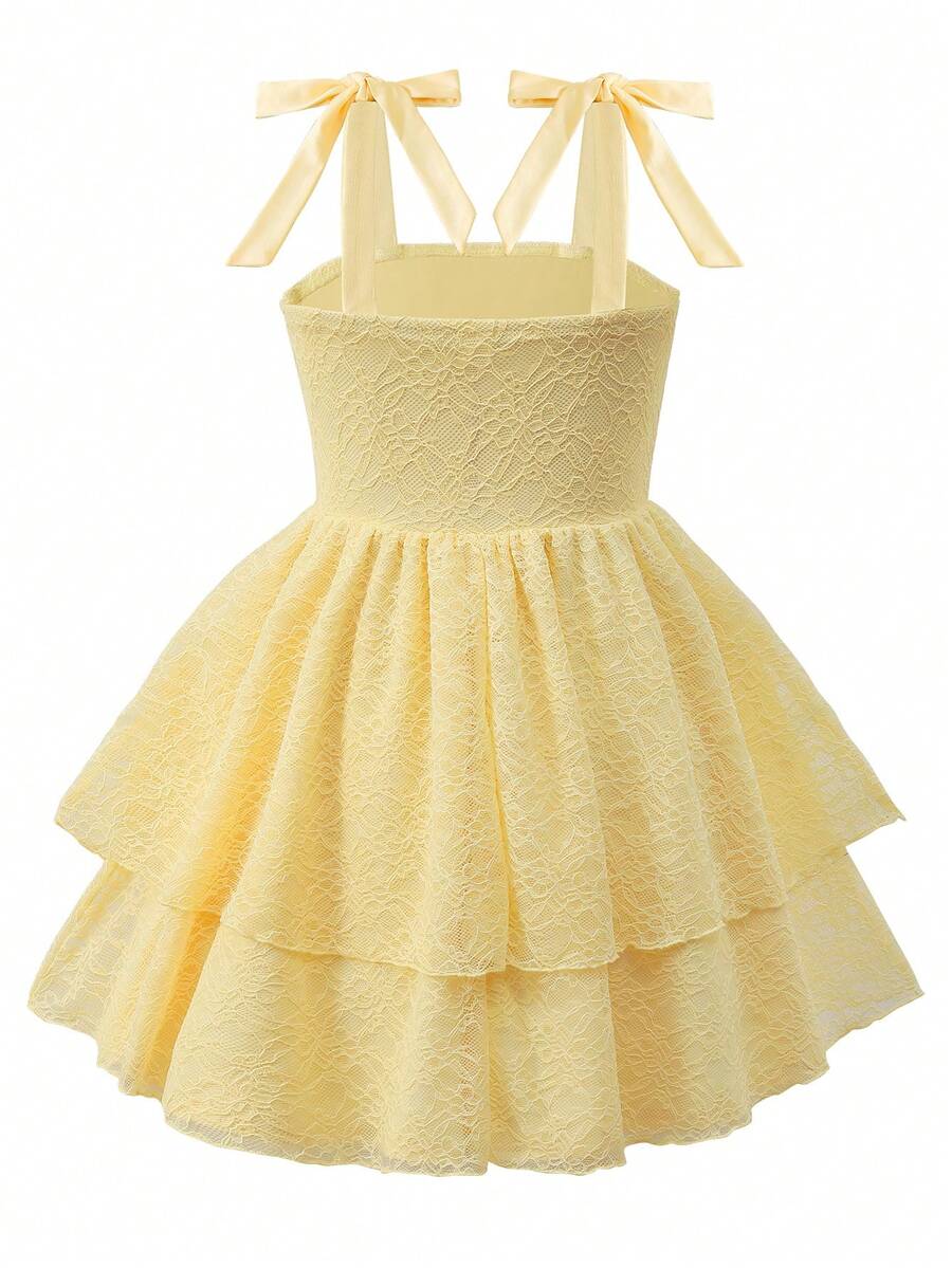 Tween girl wearing a pink tiered off-the-shoulder midi dress with shirred high waist and layered hem