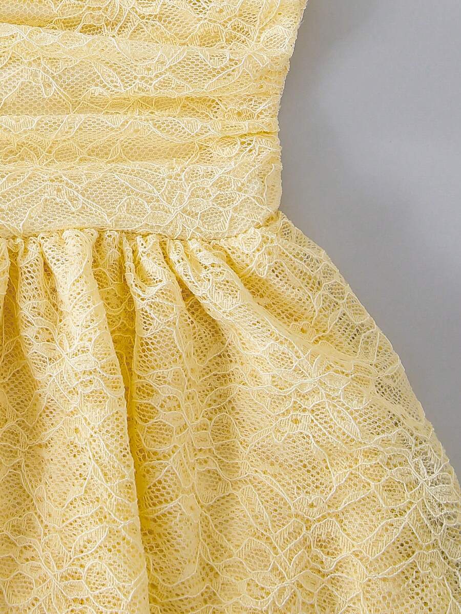 Tween girl wearing a pink tiered off-the-shoulder midi dress with shirred high waist and layered hem