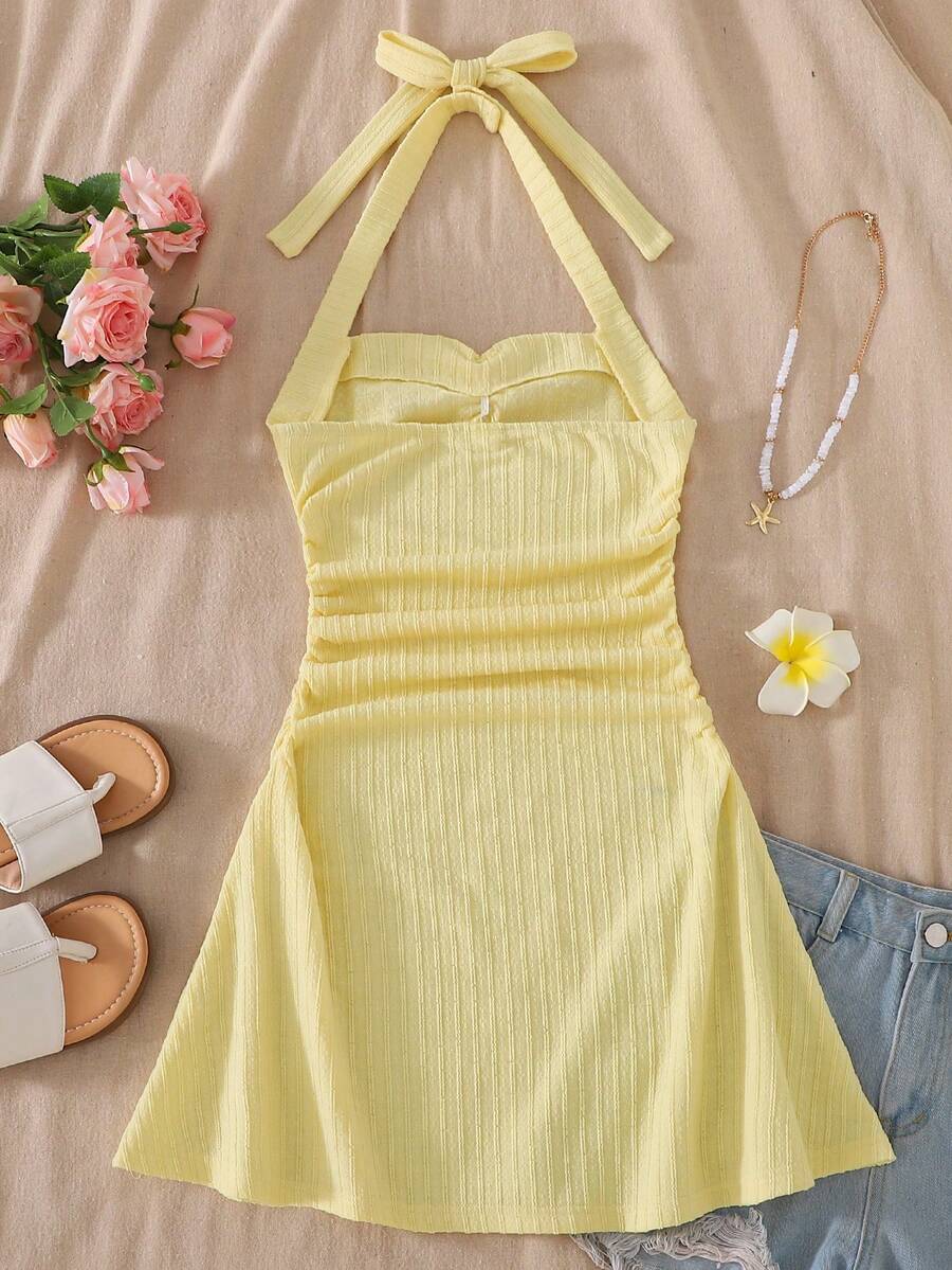 Apricot tween girls sleeveless halter cami dress with appliques, bow front, zipper detail, high waist, flared hem, and short slim fit design.
