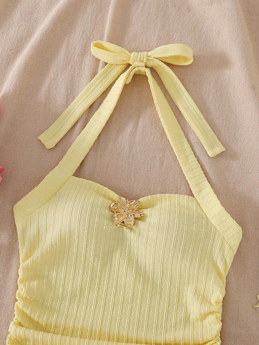 Apricot tween girls sleeveless halter cami dress with appliques, bow front, zipper detail, high waist, flared hem, and short slim fit design.