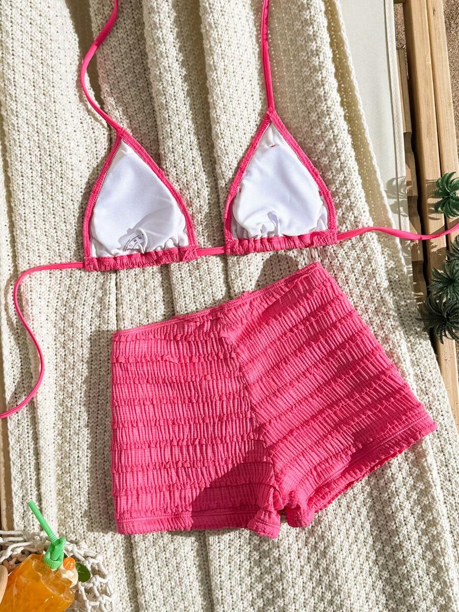 Women's apricot two-piece swimsuit set with a halter tie-back top and matching high stretch shorts.