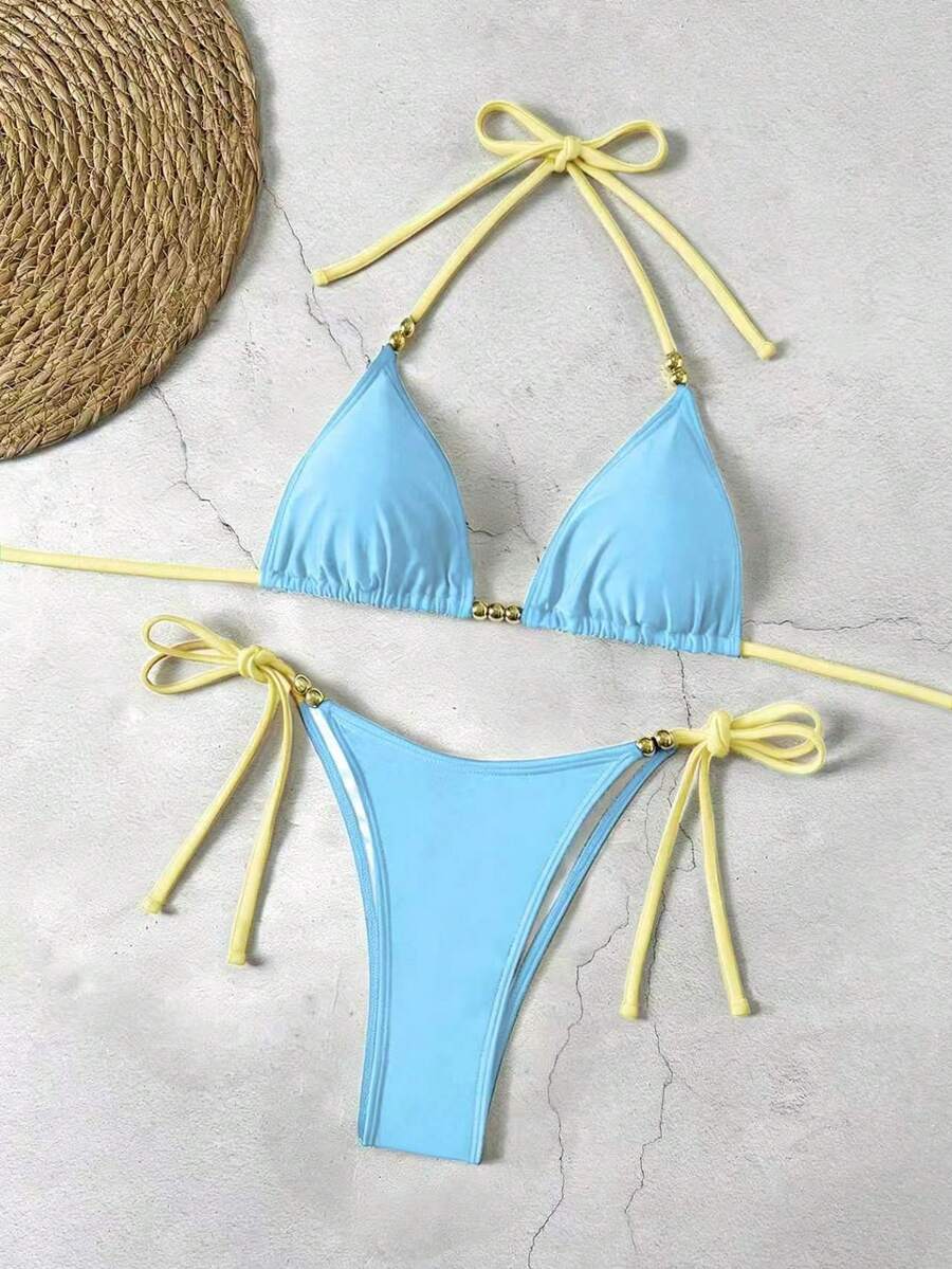Women's black halter bikini set featuring triangle cups with gold bead decor and tie-back closure