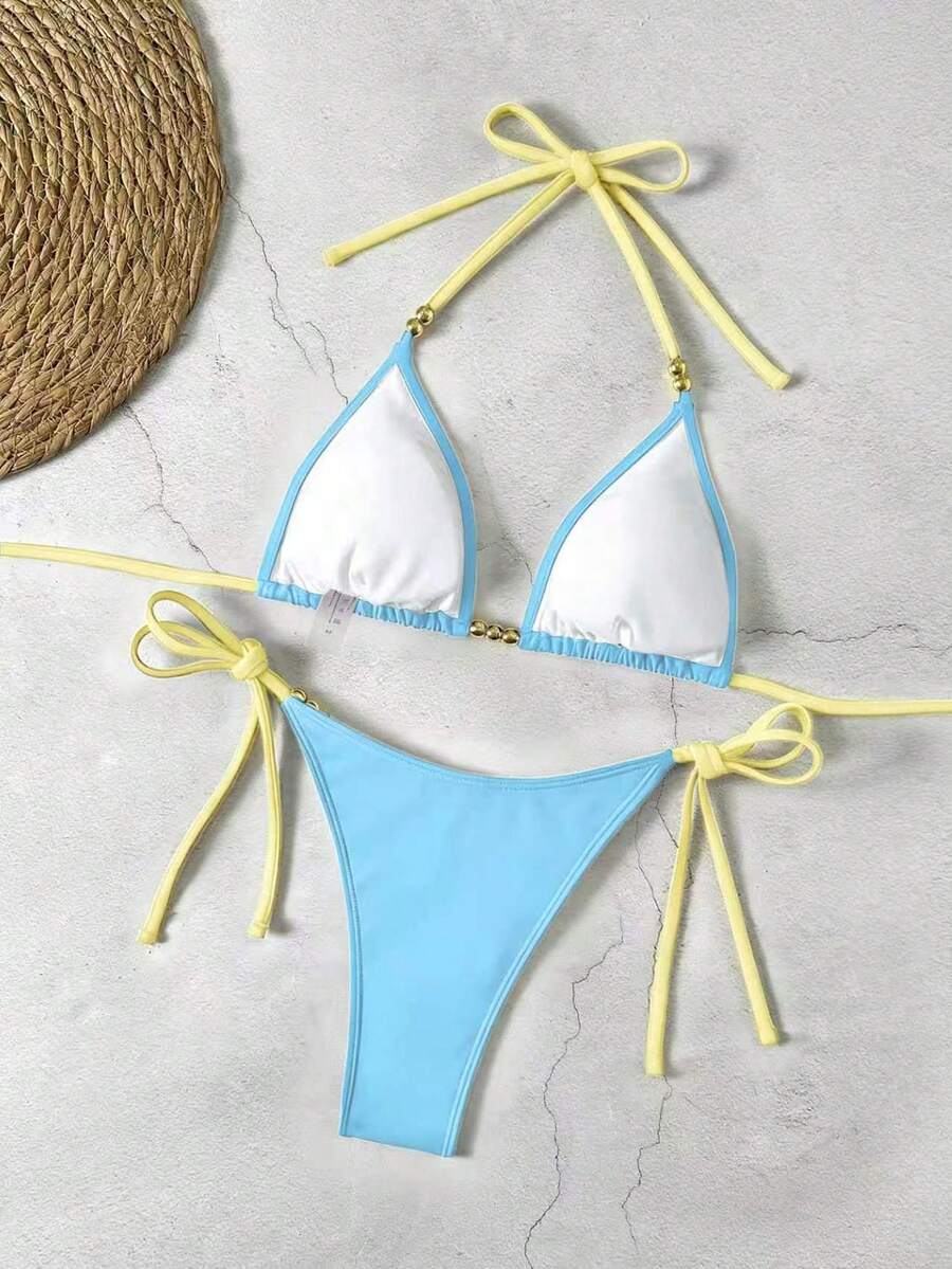 Women's black halter bikini set featuring triangle cups with gold bead decor and tie-back closure
