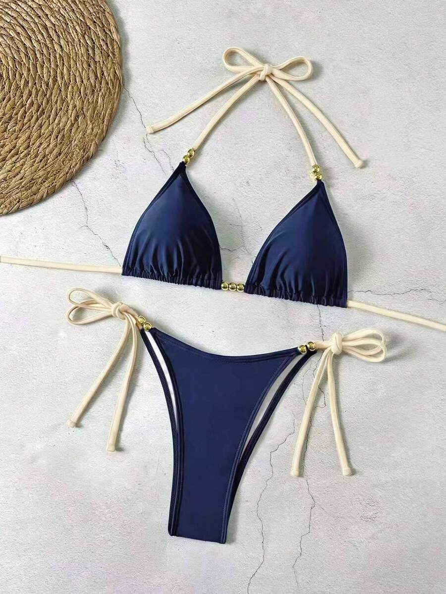 Women's black halter bikini set featuring triangle cups with gold bead decor and tie-back closure