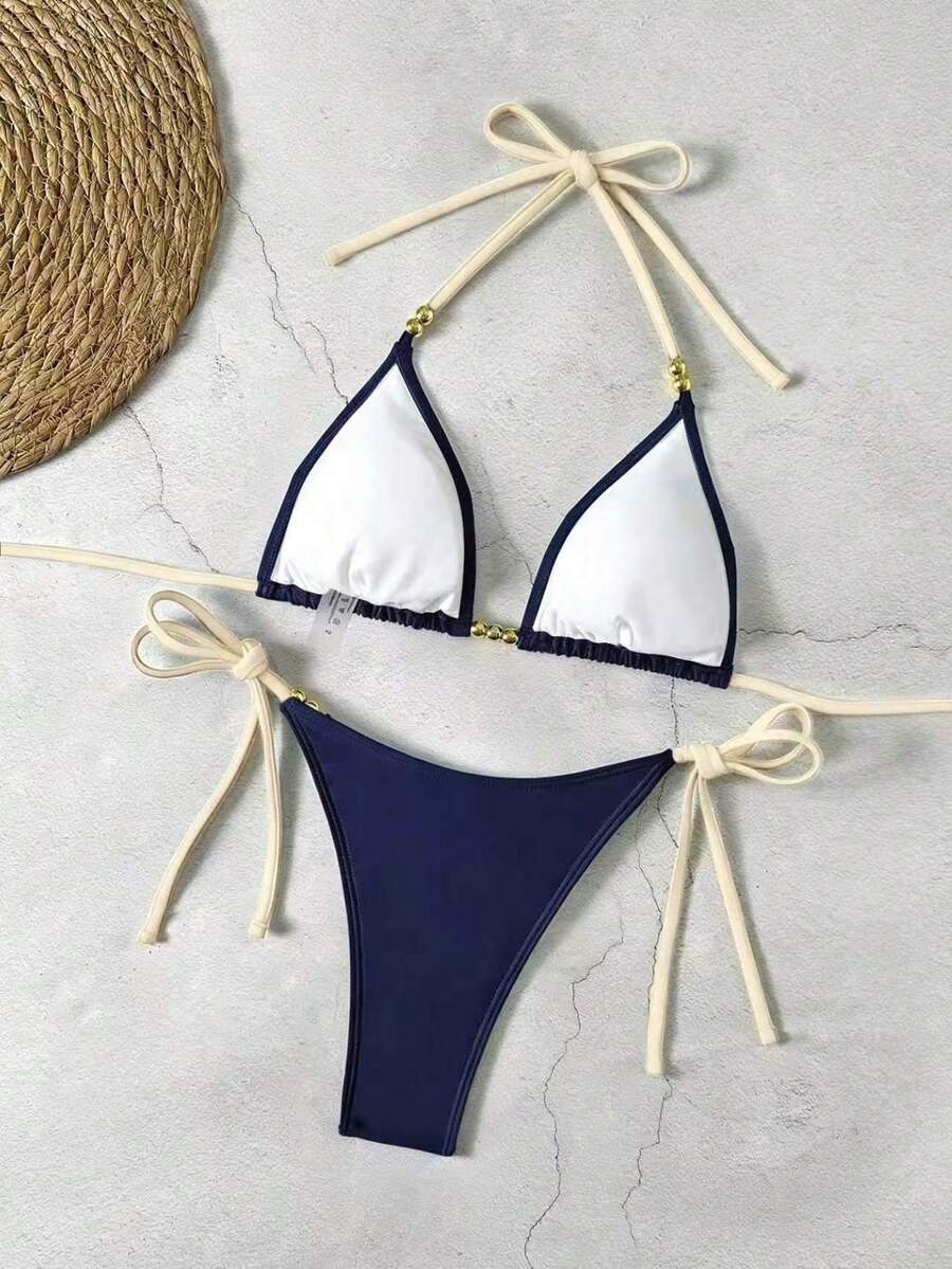 Women's black halter bikini set featuring triangle cups with gold bead decor and tie-back closure