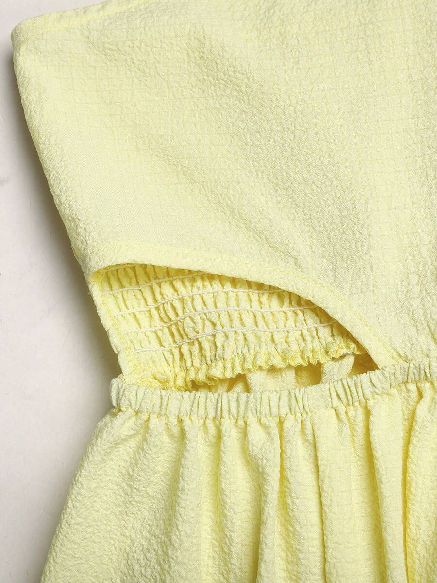 Tween girl yellow long halter dress with cutout waist, split detail, shirred textured fabric, sleeveless design, high waist, and flared hem for beach vacation wear.